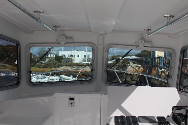 Slide: The Image of Interior view of 2024 Steiger Craft 31 Miami boat cabin with large windows. - 26