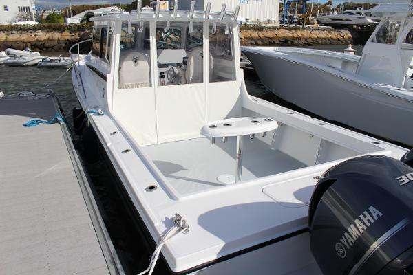 Slide: The Image of 2024 Steiger Craft 31 Miami boat docked, featuring spacious deck and Yamaha outboard motor. - 3