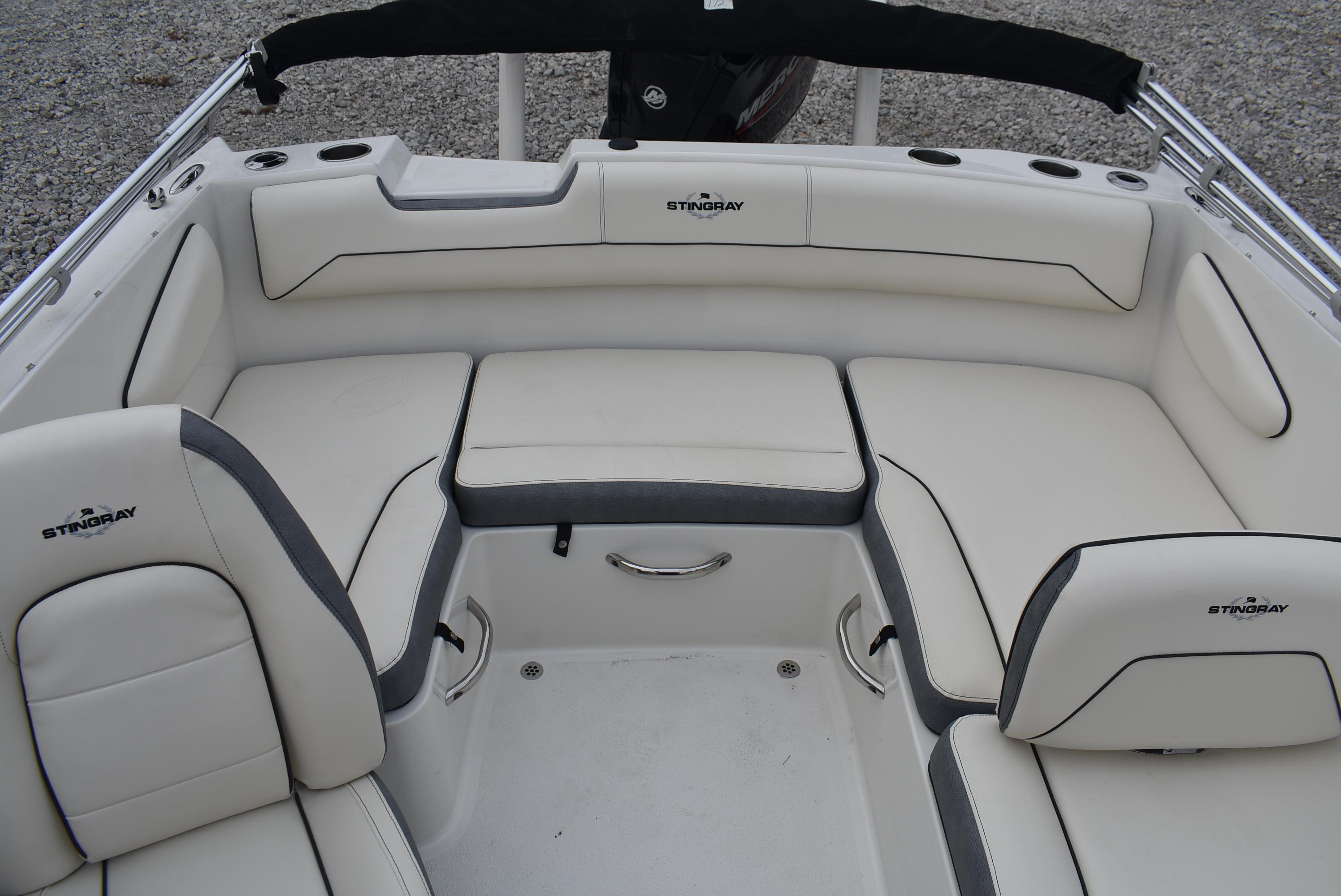 Slide: The Image of 2023 Stingray 172SC boat interior with white cushioned seating. - 12