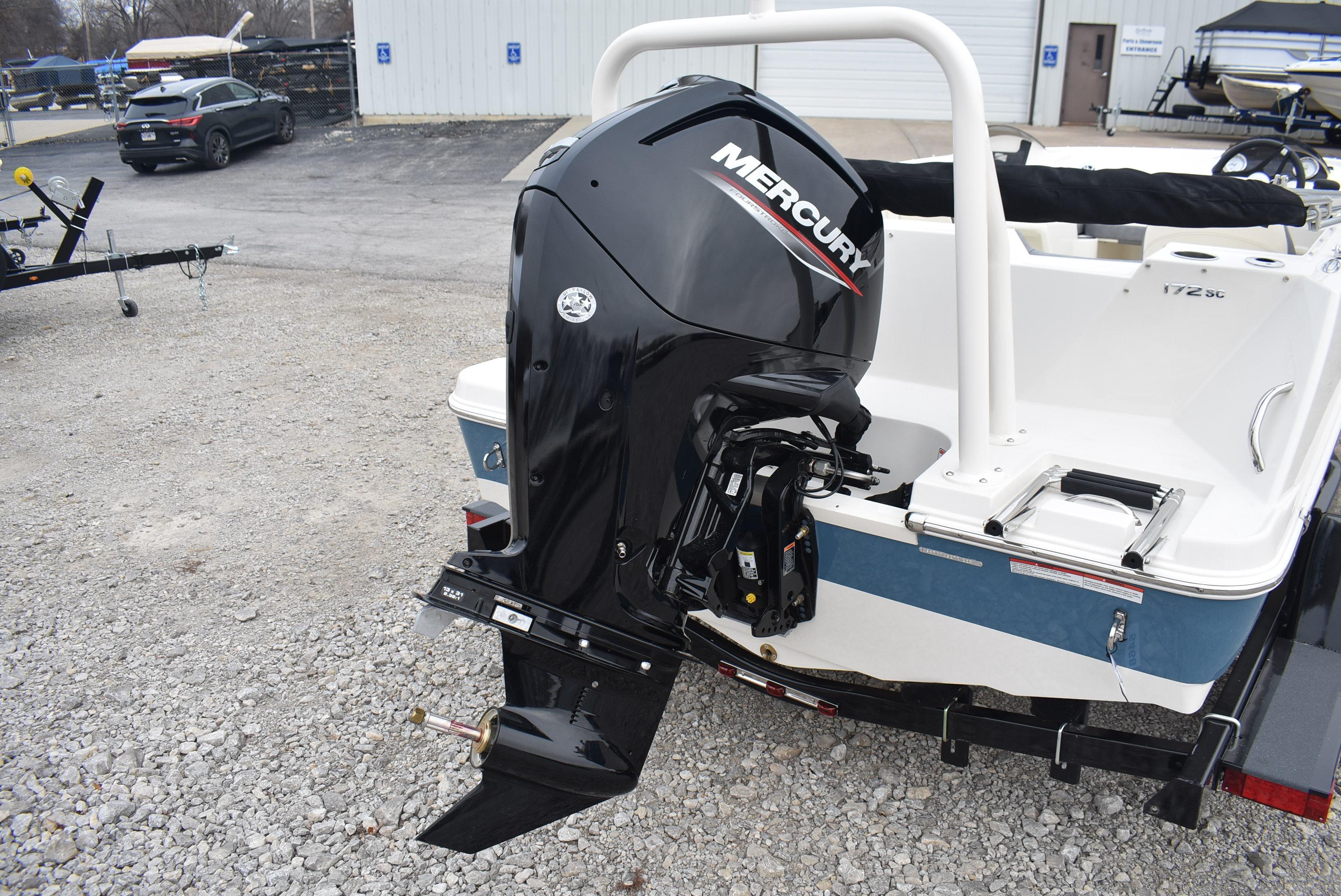 Slide: The Image of 2023 Stingray 172SC boat with Mercury outboard motor on gravel lot. - 4