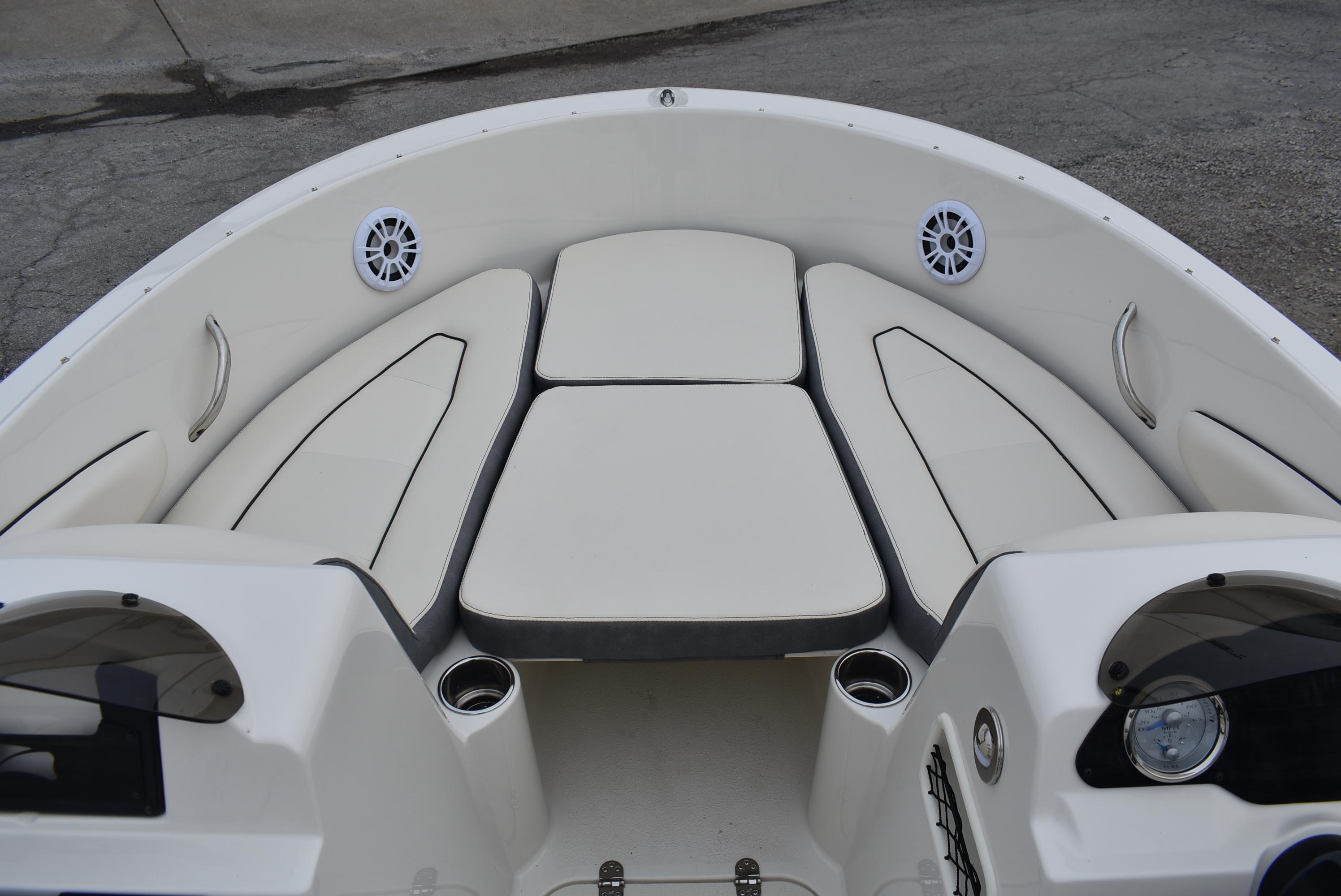 Slide: The Image of 2023 Stingray 172SC boat interior with white cushioned seating and cup holders. - 6
