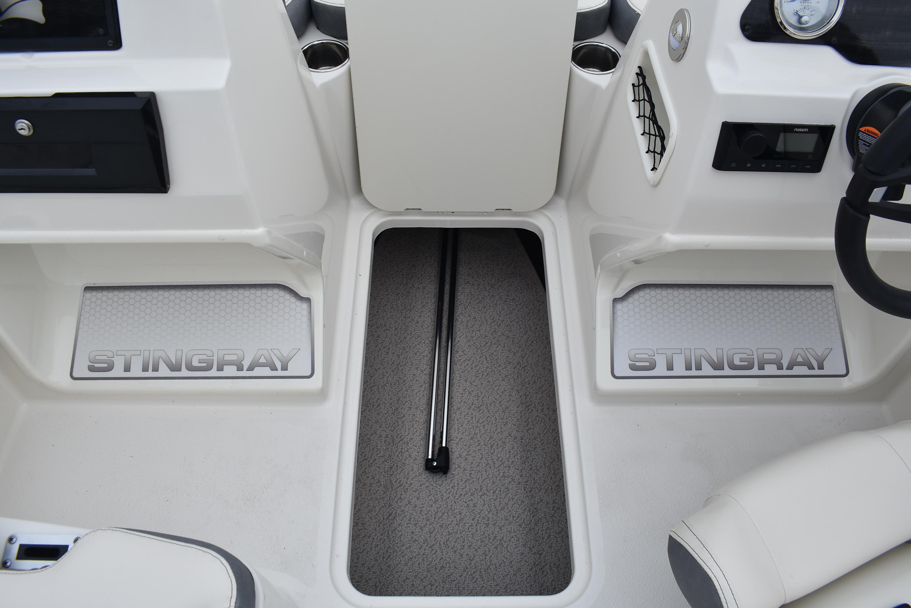 Slide: The Image of 2023 Stingray 172SC boat interior with branded flooring and steering console. - 8