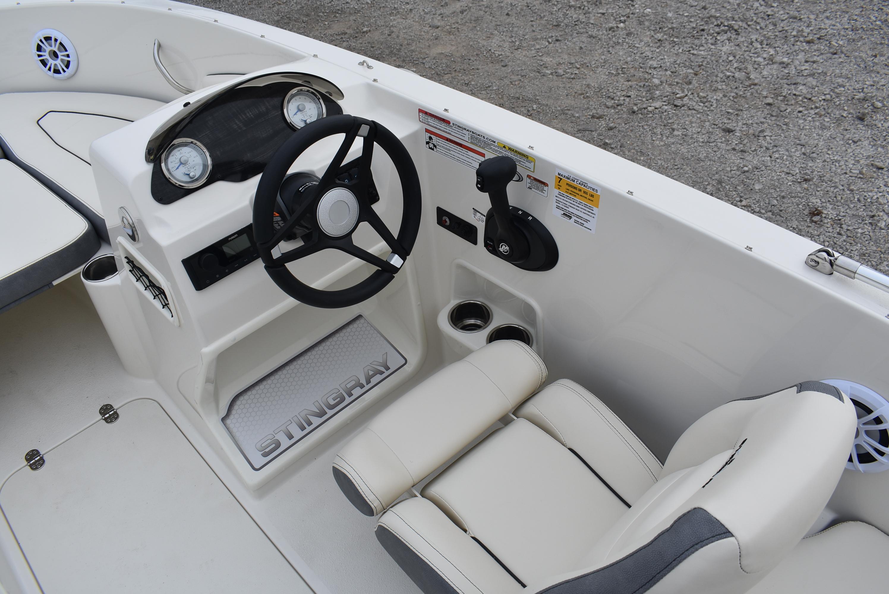 Slide: The Image of 2023 Stingray 172SC boat interior with steering wheel and seating. - 9