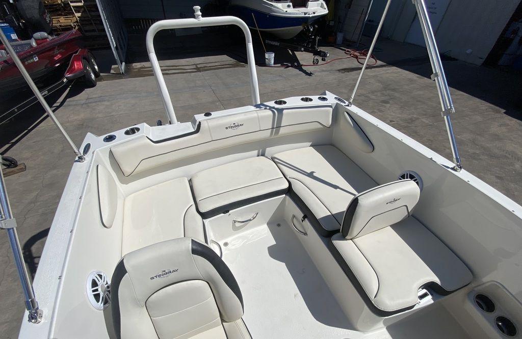 Slide: The Image of 2024 Stingray 172SC boat interior with white seating and cup holders. - 10