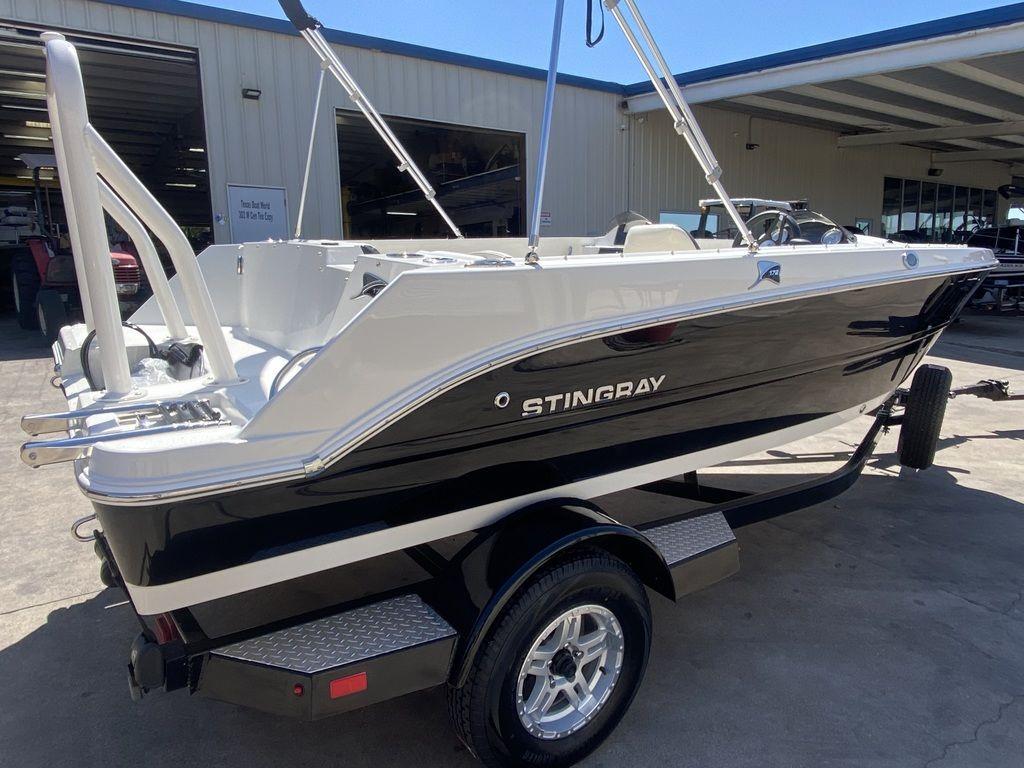 Slide: The Image of 2024 Stingray 172SC boat on a trailer in a marina. - 2