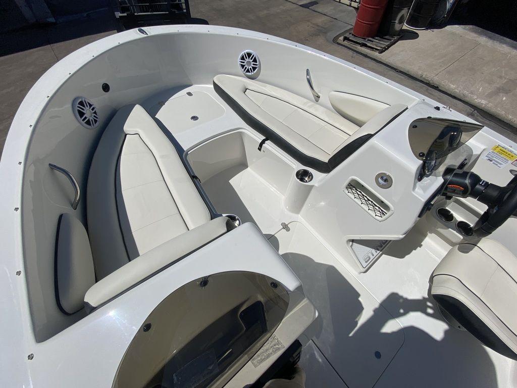 Slide: The Image of 2024 Stingray 172SC boat interior with white seating and steering console. - 5
