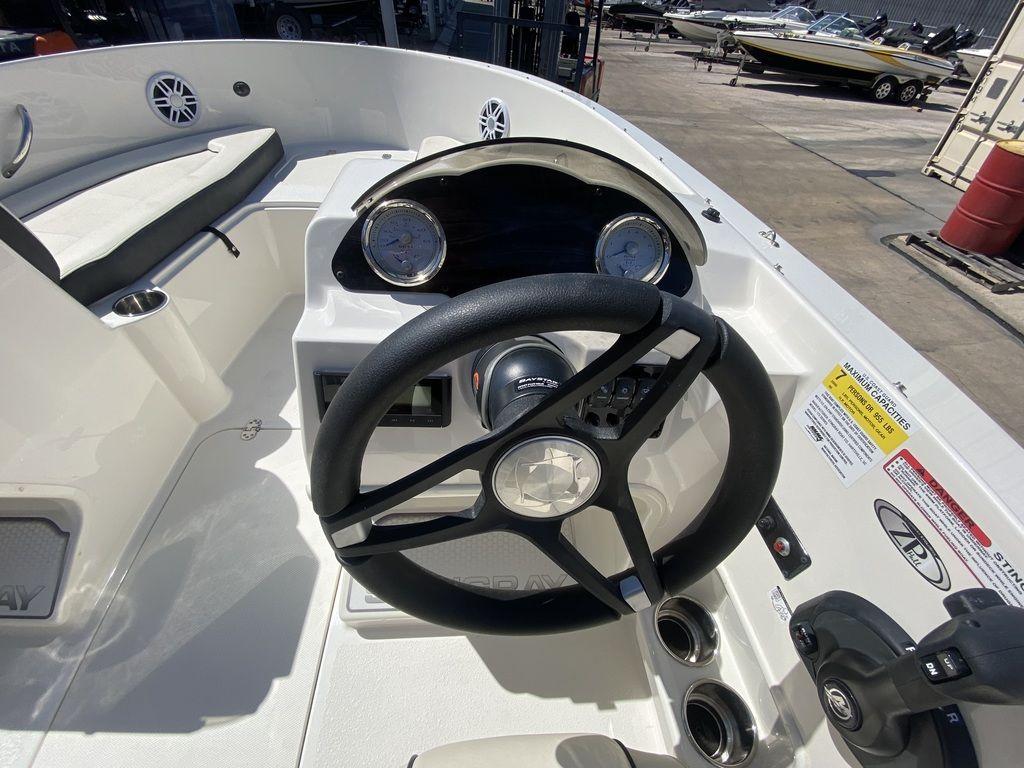 Slide: The Image of 2024 Stingray 172SC boat dashboard with steering wheel and gauges. - 8
