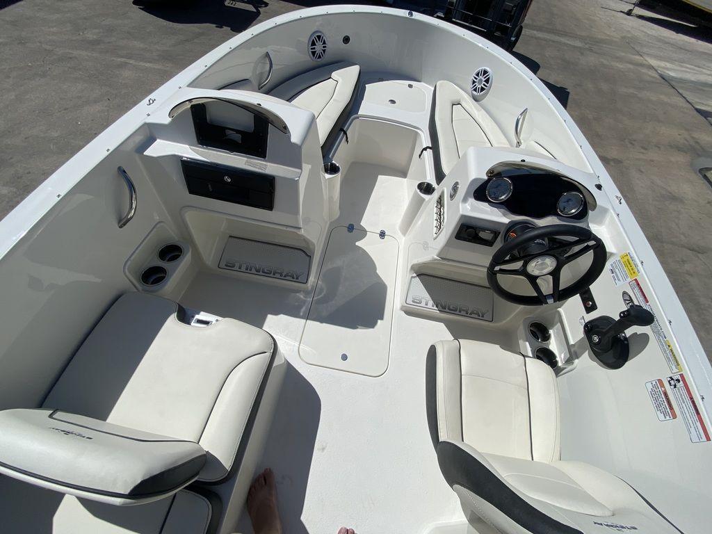 Slide: The Image of 2024 Stingray 172SC boat interior with white seating and steering console. - 9