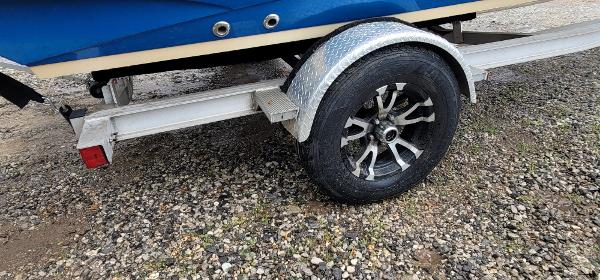 Slide: The Image of 2019 Stingray 186 CC boat trailer with alloy wheel on gravel. - 11