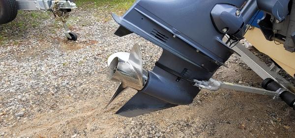 Slide: The Image of 2019 Stingray 186 CC boat motor and propeller on gravel surface. - 12