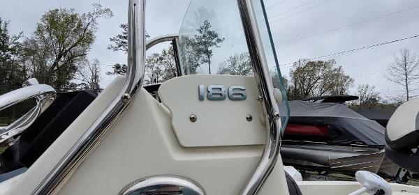 Slide: The Image of 2019 Stingray 186 CC boat, close-up of console and windshield, outdoors. - 9