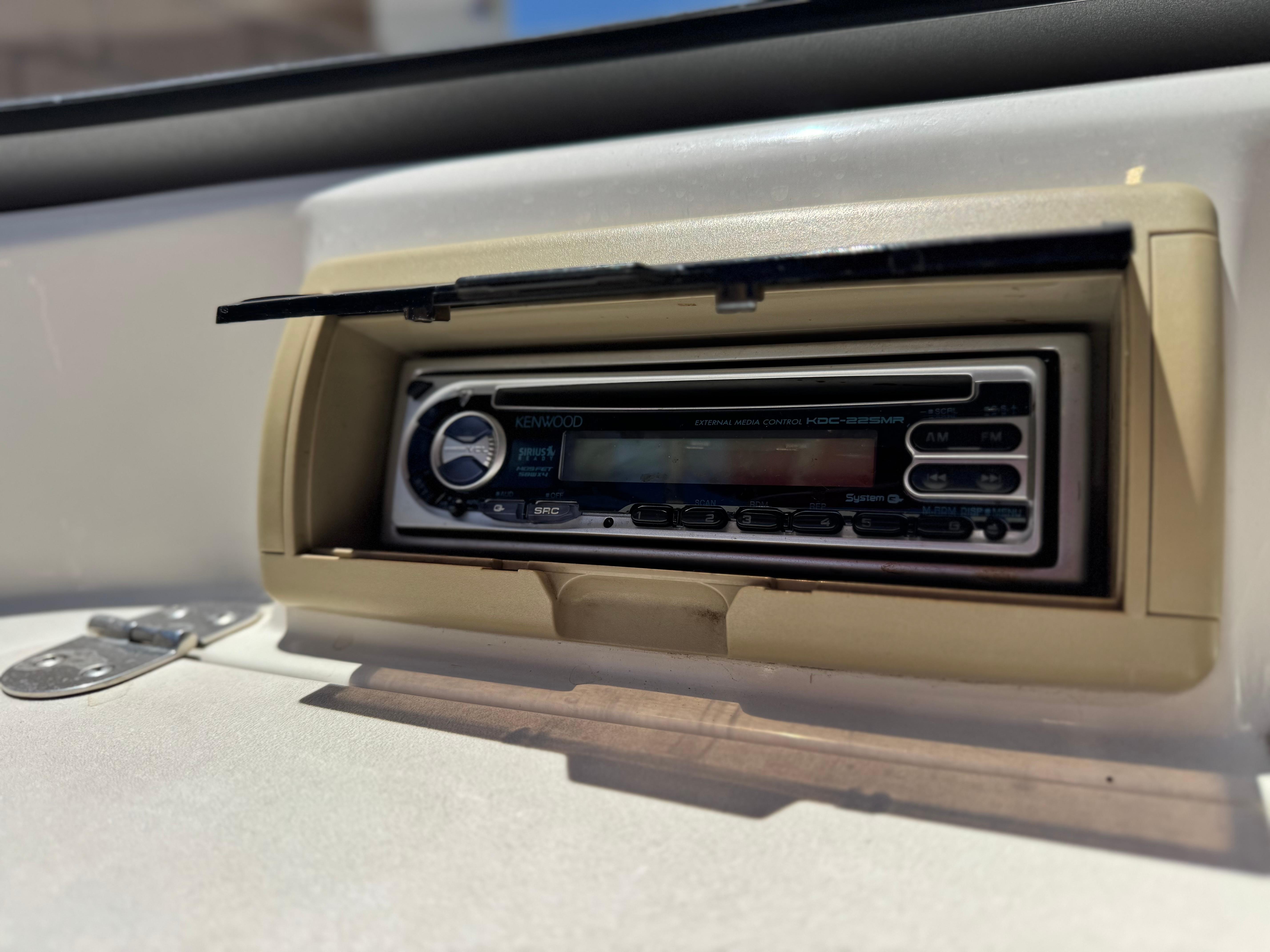 Slide: The Image of Kenwood stereo system in a 2006 Stingray 195 LR boat dashboard. - 11