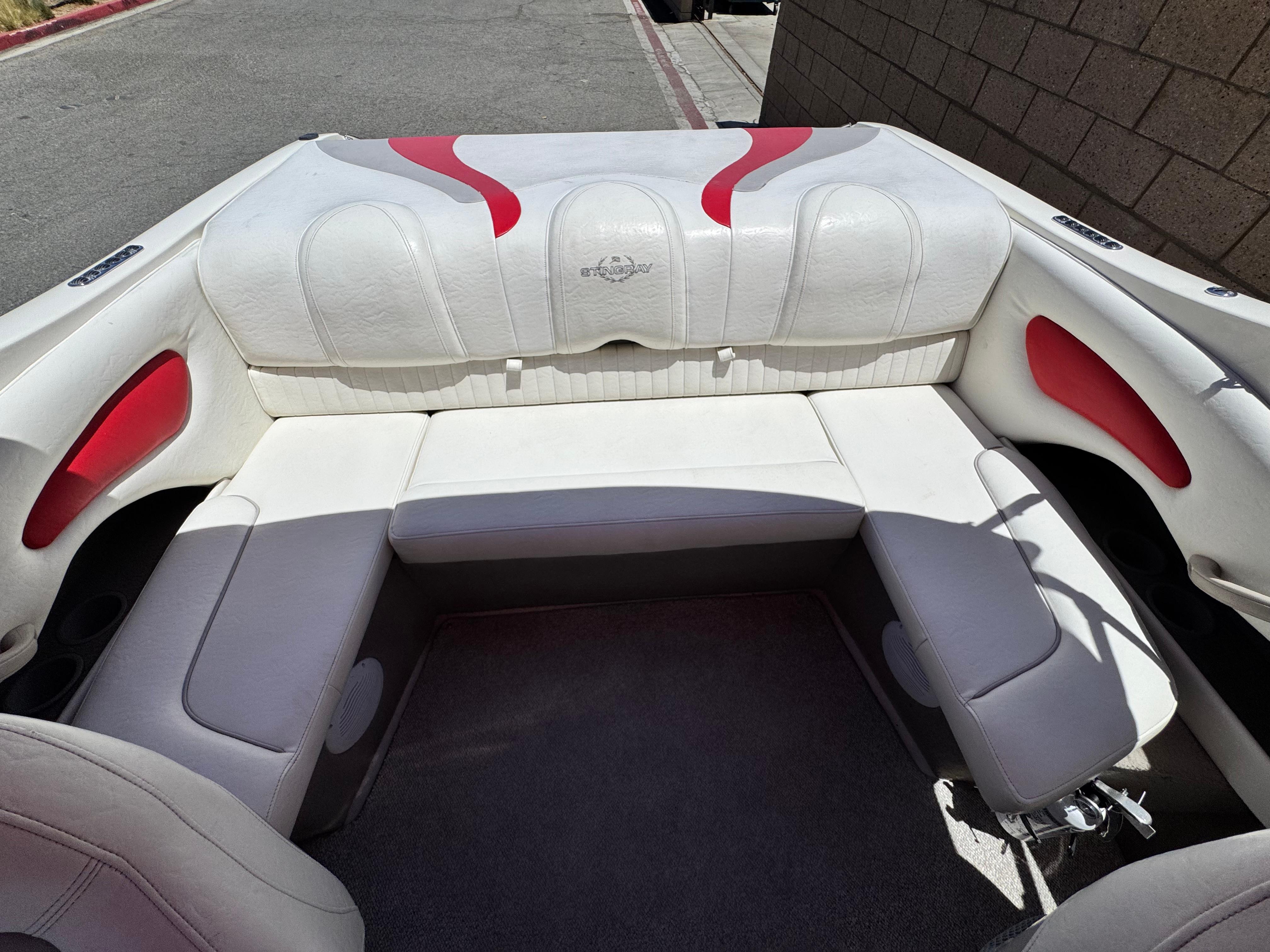 Slide: The Image of 2006 Stingray 195 LR boat interior with white and red seating. - 12
