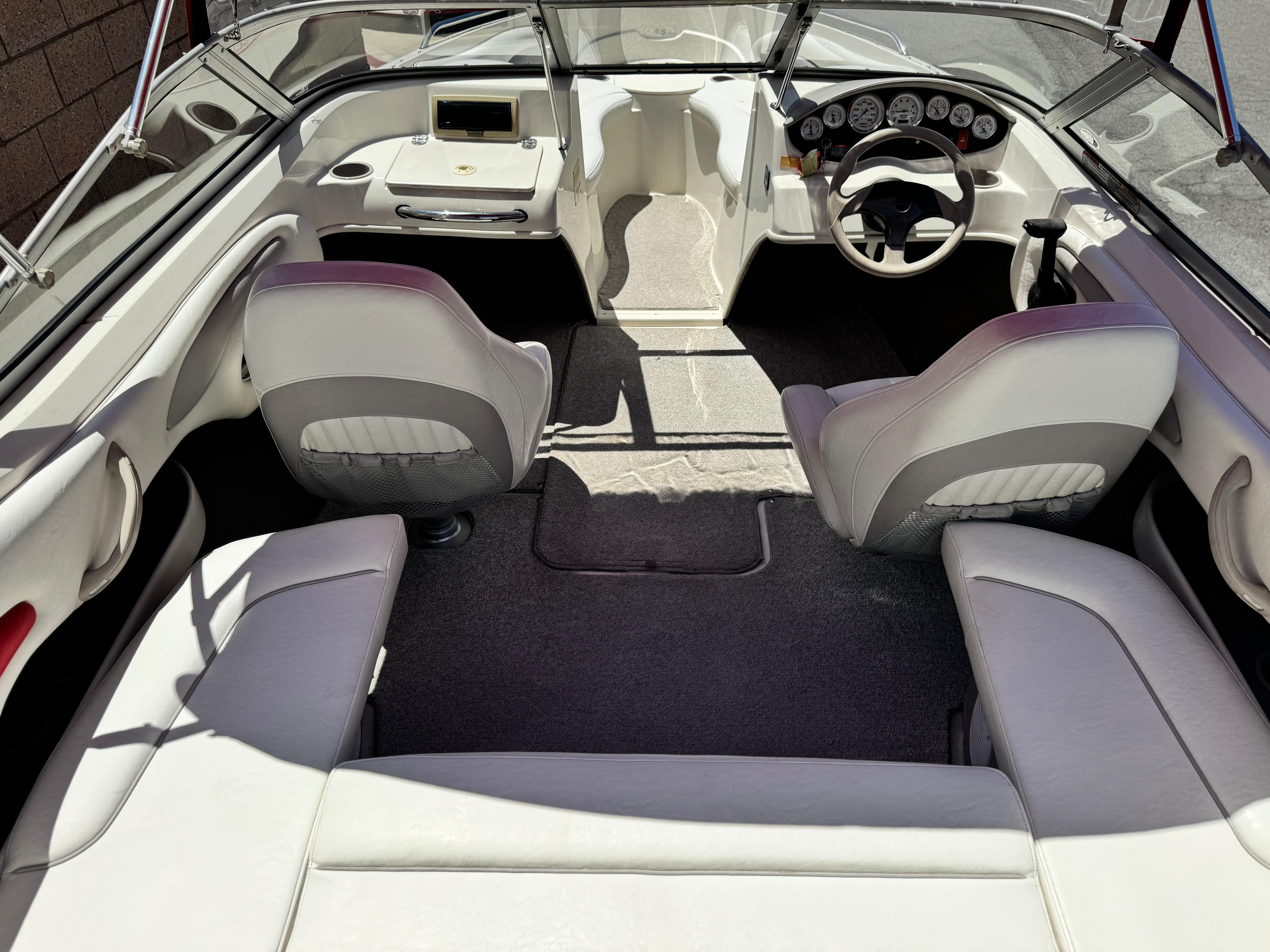 Slide: The Image of Interior of a 2006 Stingray 195 LR boat with seating and dashboard. - 15