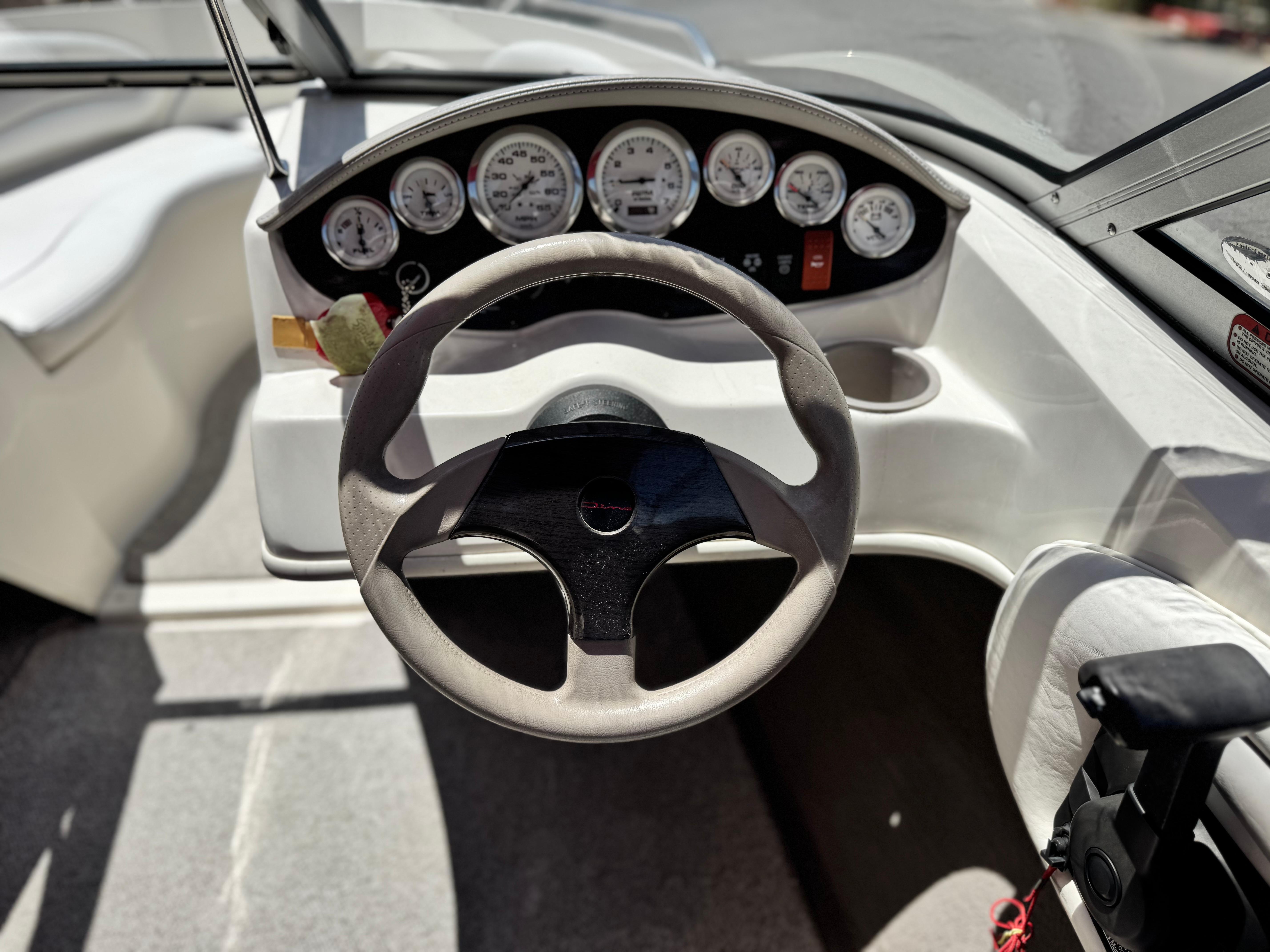 Slide: The Image of 2006 Stingray 195 LR boat dashboard with steering wheel and instrument panel. - 18