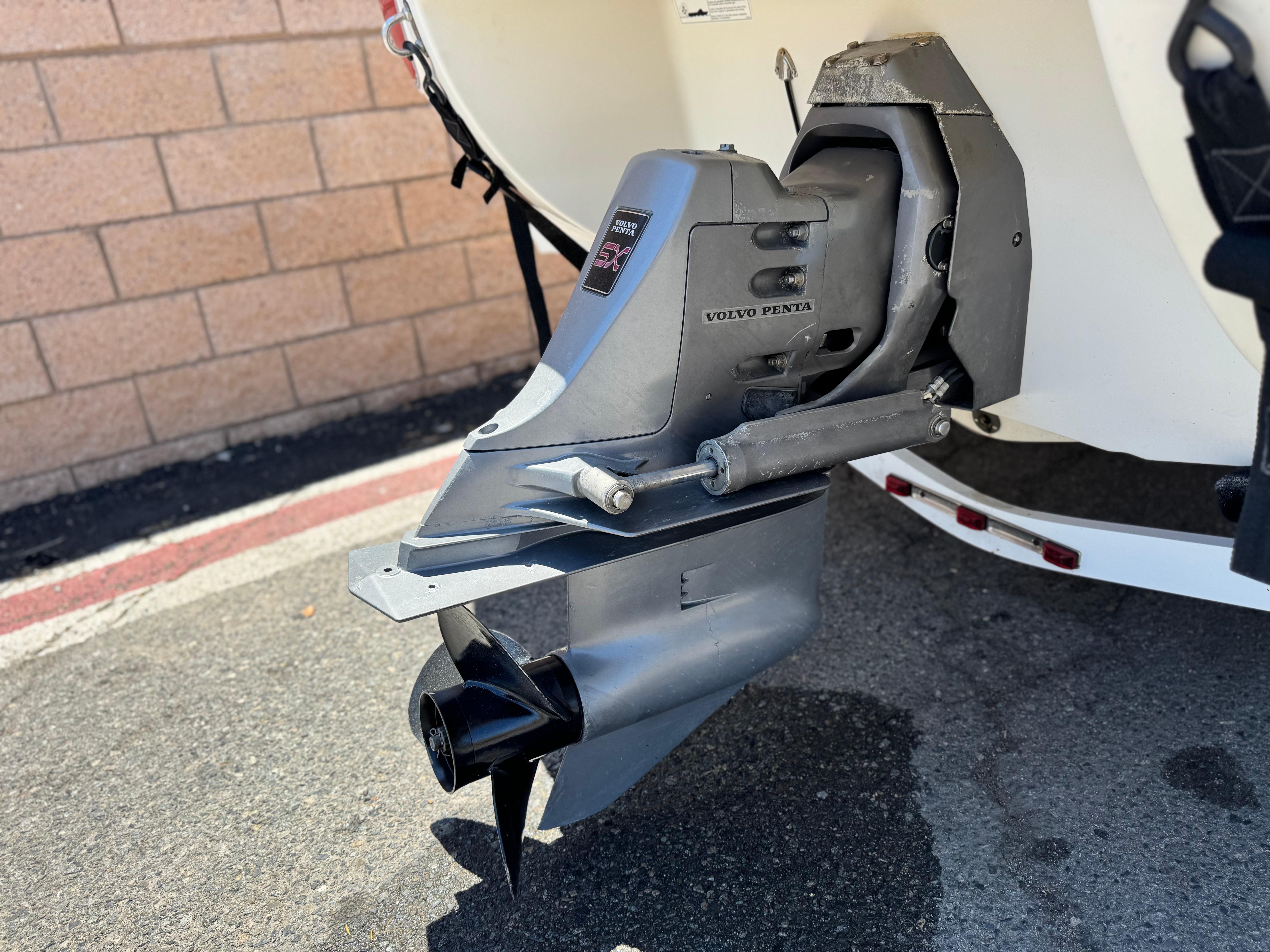 Slide: The Image of 2006 Stingray 195 LR boat with Volvo Penta outdrive, parked on pavement. - 7