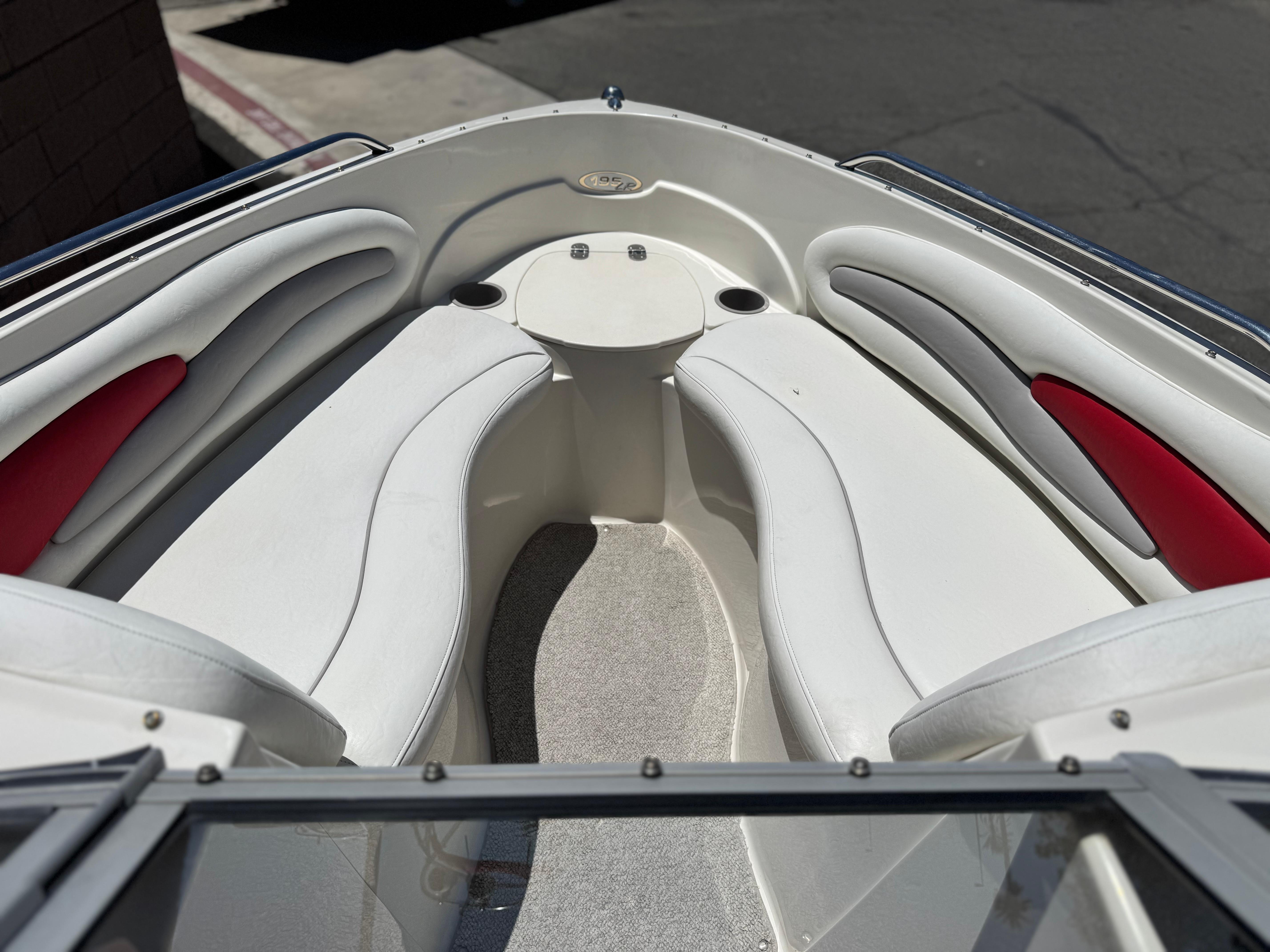 Slide: The Image of 2006 Stingray 195 LR boat interior with white and red seating, viewed from the bow. - 9