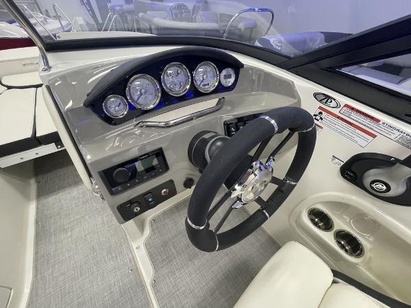 Slide: The Image of 2022 Stingray 215LR boat dashboard with steering wheel and instrument panel. - 10