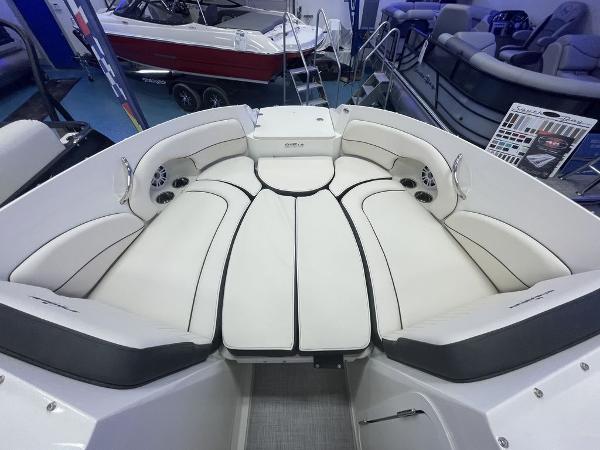 Slide: The Image of 2022 Stingray 215LR boat interior with white cushioned seating. - 11