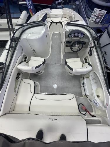 Slide: The Image of 2022 Stingray 215LR boat interior with white seating and modern dashboard. - 3