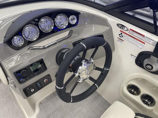 Slide: The Image of 2022 Stingray 215LR boat dashboard with steering wheel, gauges, and controls. - 4
