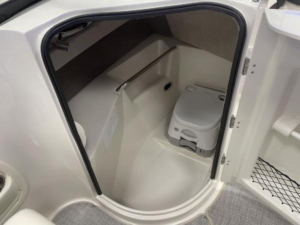 Slide: The Image of 2022 Stingray 215LR boat interior with compact marine toilet. - 5