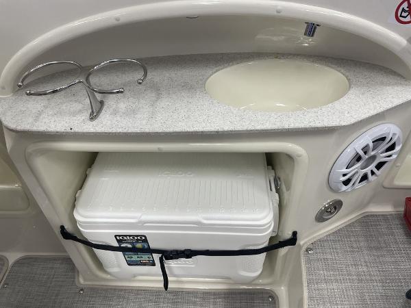 Slide: The Image of 2022 Stingray 215LR boat interior with sink, cooler, and speaker. - 7