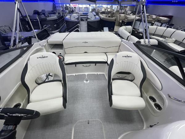 Slide: The Image of 2022 Stingray 215LR boat interior with white seating and modern design. - 8