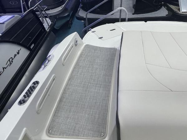 Slide: The Image of 2022 Stingray 215LR boat interior with cushioned seating and non-slip flooring. - 9