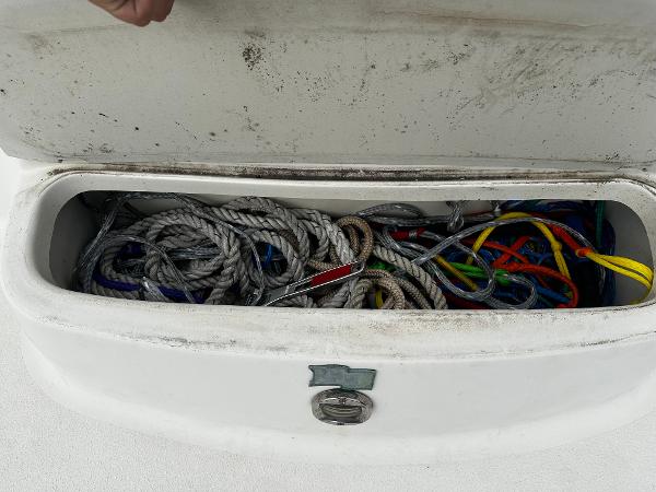 Slide: The Image of Storage compartment with ropes on a 2011 Stingray 250 LR boat. - 11