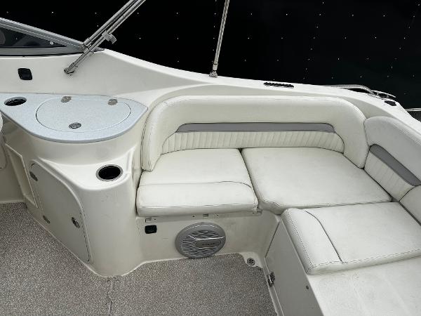 Slide: The Image of 2011 Stingray 250 LR boat interior with white cushioned seating and storage compartments. - 17