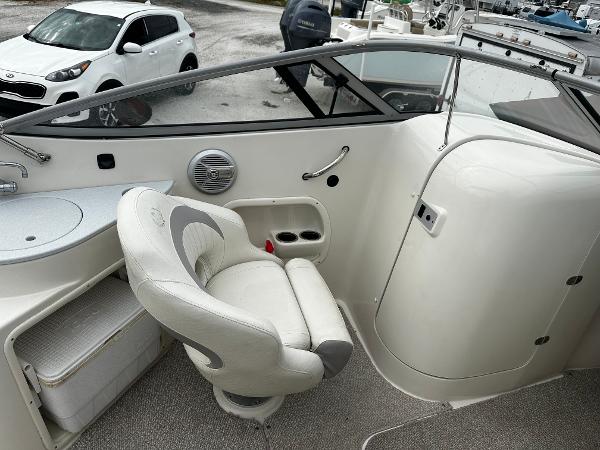 Slide: The Image of 2011 Stingray 250 LR boat interior with captain's chair and dashboard. - 19
