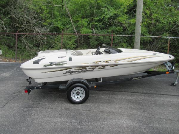 Slide: The Image of 2004 Sugar Sand Tango Xtreme boat on a trailer, parked outdoors. - 0