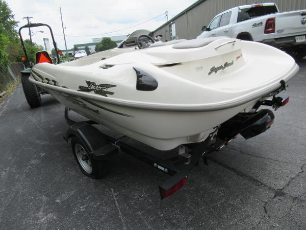 Slide: The Image of 2004 Sugar Sand Tango Xtreme boat on a trailer in a parking lot. - 1