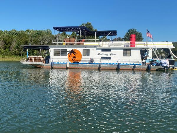 Slide: The Image of 1987 Sumerset Houseboat Setting Sun docked on a serene lake. - 0