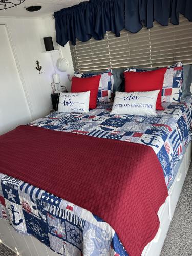 Slide: The Image of Cozy bedroom in a 1987 Sumerset Houseboat with nautical-themed decor. - 10