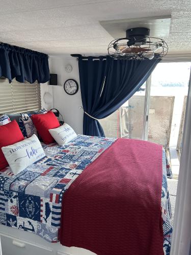 Slide: The Image of Cozy bedroom in a 1987 Sumerset Houseboat with nautical-themed decor. - 11