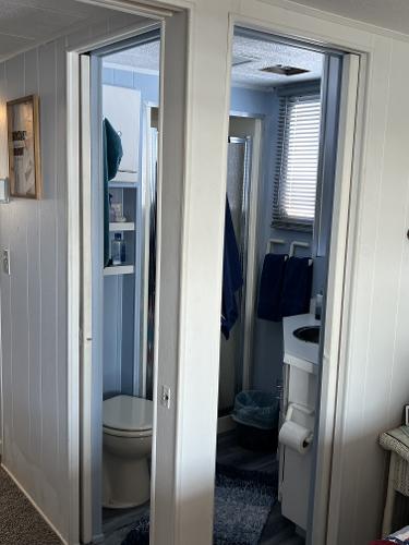 Slide: The Image of 1987 Sumerset Houseboat bathroom with shower, toilet, and sink. - 12