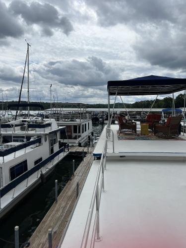 Slide: The Image of 1987 Sumerset Houseboat docked at a marina under cloudy skies. - 17