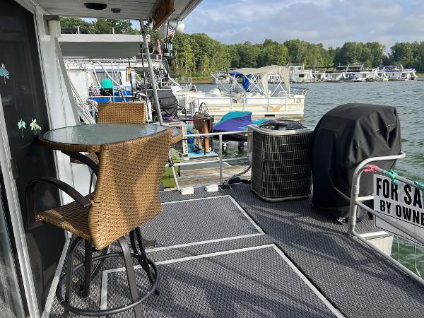 Slide: The Image of 1987 Sumerset Houseboat for sale, docked with outdoor seating and lake view. - 18