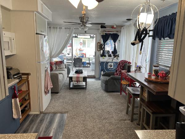 Slide: The Image of Cozy 1987 Sumerset houseboat interior with modern kitchen, dining area, and living space. - 2
