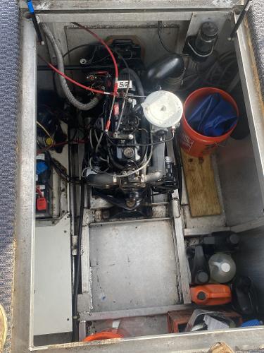Slide: The Image of 1987 Sumerset Houseboat engine compartment with various tools and equipment. - 20