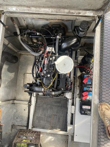 Slide: The Image of Engine compartment of a 1987 Sumerset Houseboat showing the engine and batteries. - 22