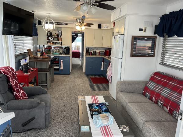Slide: The Image of 1987 Sumerset Houseboat interior with cozy living area, kitchen, and dining space. - 3
