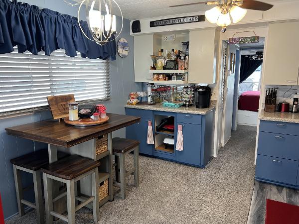 Slide: The Image of 1987 Sumerset Houseboat interior with dining area, kitchen, and cozy decor. - 4