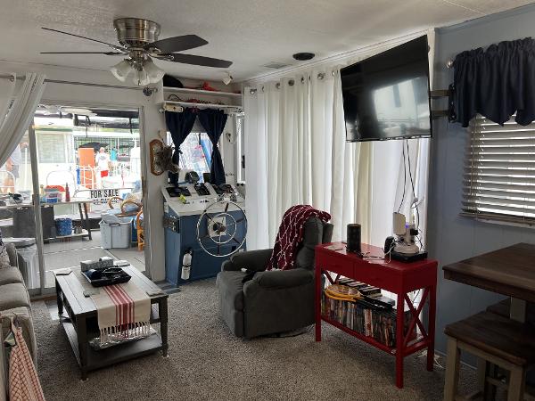 Slide: The Image of Interior of a 1987 Sumerset Houseboat with cozy living area and helm station. - 6
