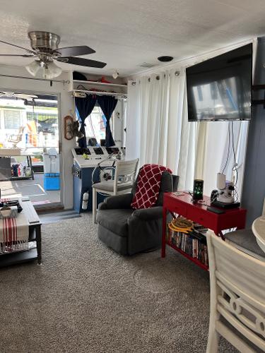 Slide: The Image of Interior of a 1987 Sumerset Houseboat with cozy living area and modern amenities. - 7