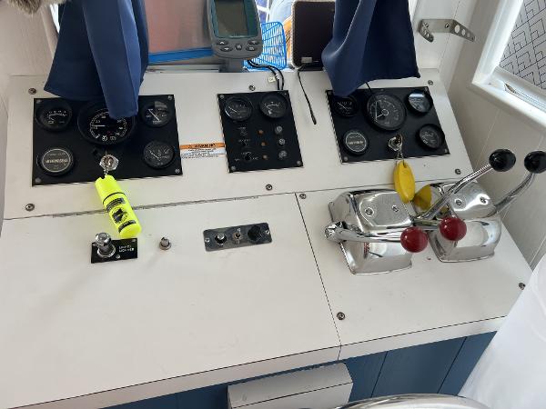 Slide: The Image of Control panel of a 1987 Sumerset Houseboat with gauges and levers. - 8