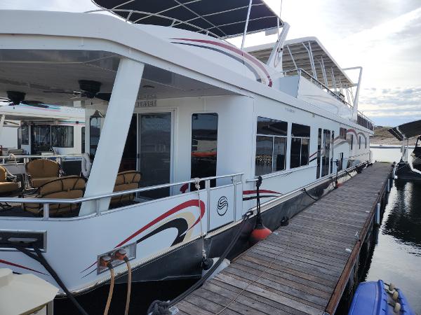 Slide: The Image of 2008 Sumerset Houseboat 20' x 100' docked, featuring spacious deck and modern design. - 1