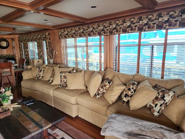 Slide: The Image of Luxurious interior of 2008 Sumerset Houseboat with beige sectional sofa and patterned pillows. - 24